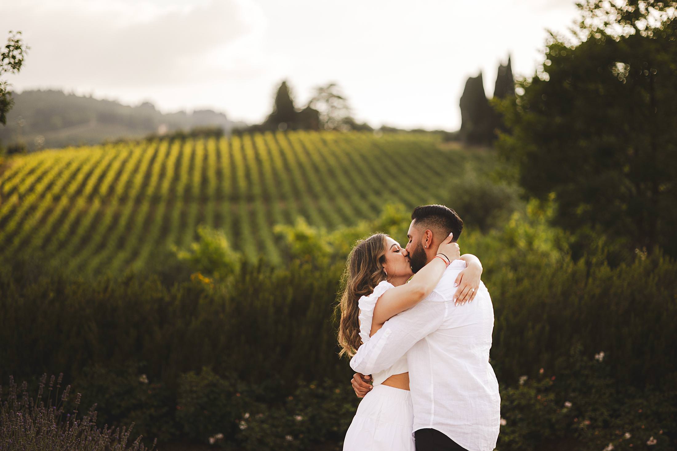 Unforgettable surprise proposal photo shoot with backdrop of vineyards and green rolling hills at Borgo del Cabreo