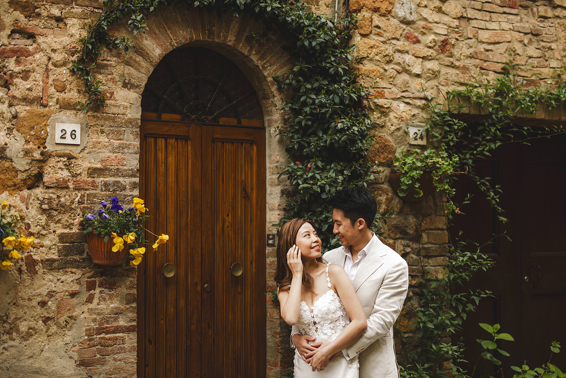 Asian couple pre-wedding portrait session in medieval streets of enchanting village of Pienza