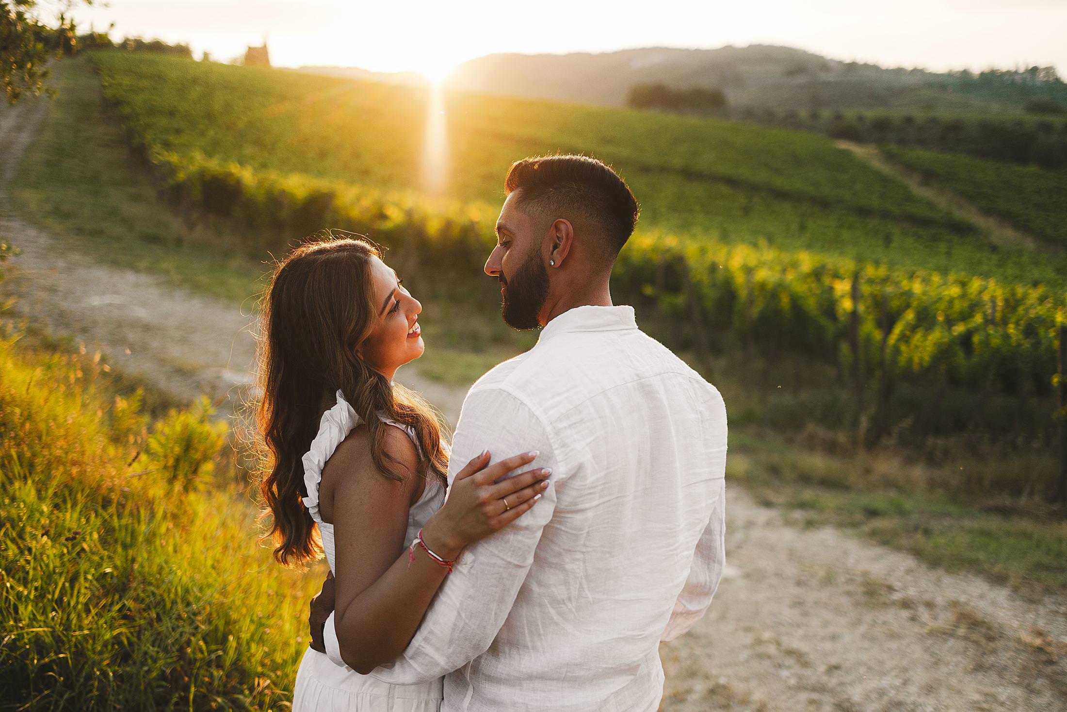 Gorgeous engagement photo session in golden hour Chianti countryside with vineyard as background